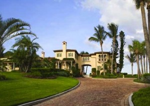 beautiful front view of luxury oceanfront estate located at 12210 Banyan Road, palm beach